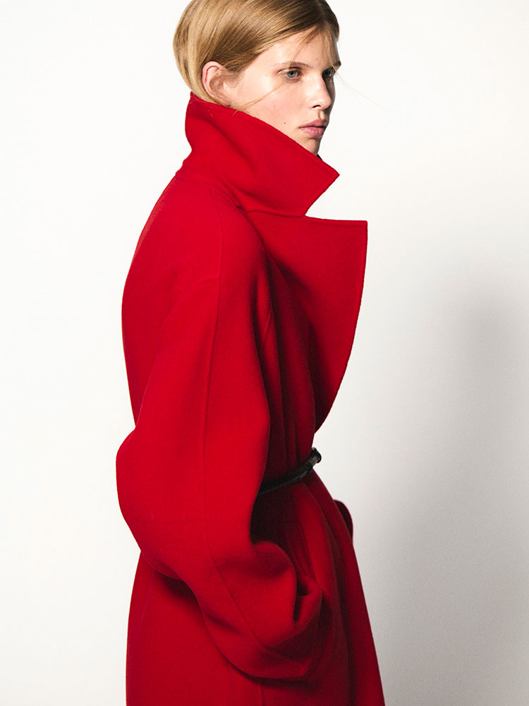 man wearing turtleneck standing on balcony